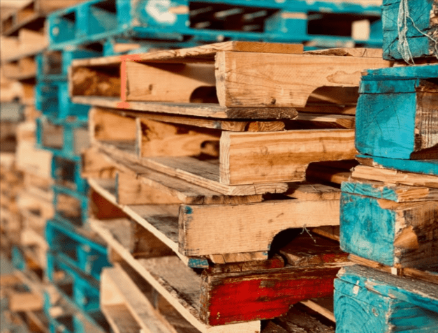 Columns of different colored wooden pallets